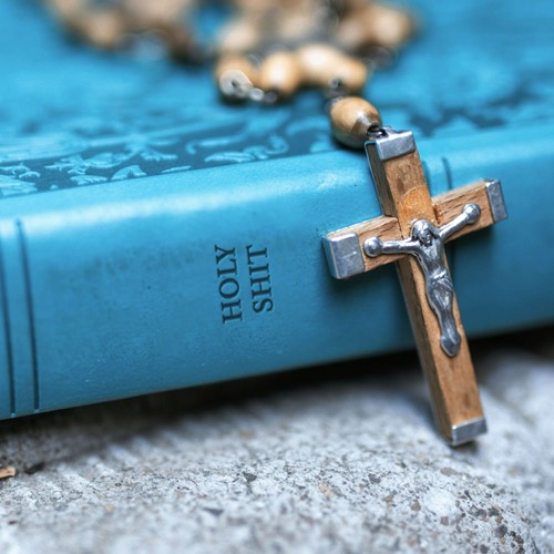 A Bible that says "Holy Shit" on the side.