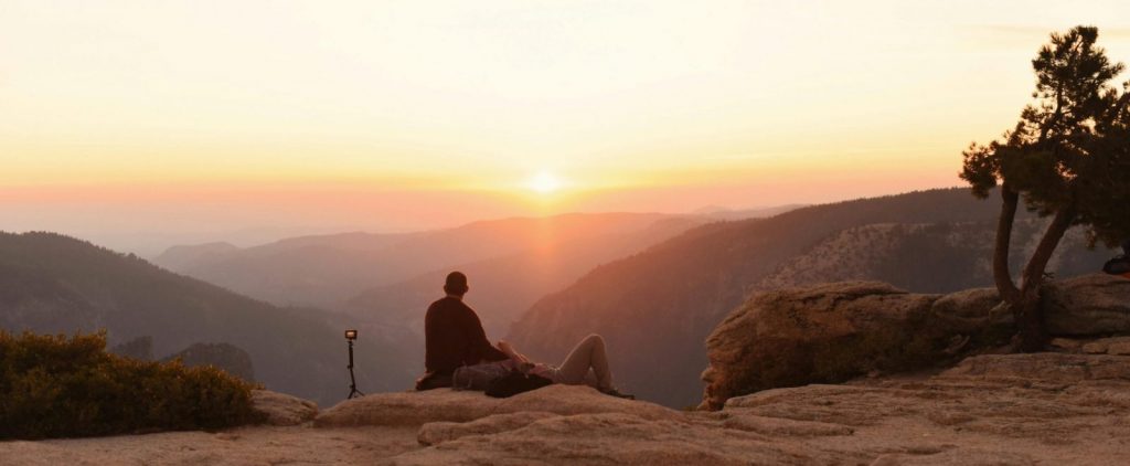 A person enjoying a tranquil sunrise view at Yosemite National Park, California.